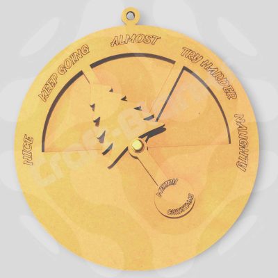 An interactive Christmas Naughty Or Nice Meter made from laser-cut MDF, featuring a 16cm round dial and a moving Christmas tree indicator on a split pin.