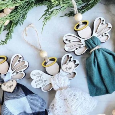Three finished Memory Angel ornaments made from MDF craft blanks, holding different pieces of fabric clothing and personalised with names