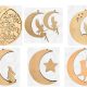 A collection of unfinished MDF moon plaques in various designs including a baying wolf, a cat on the moon, and a double-layered "Love you to the moon and back" plaque.