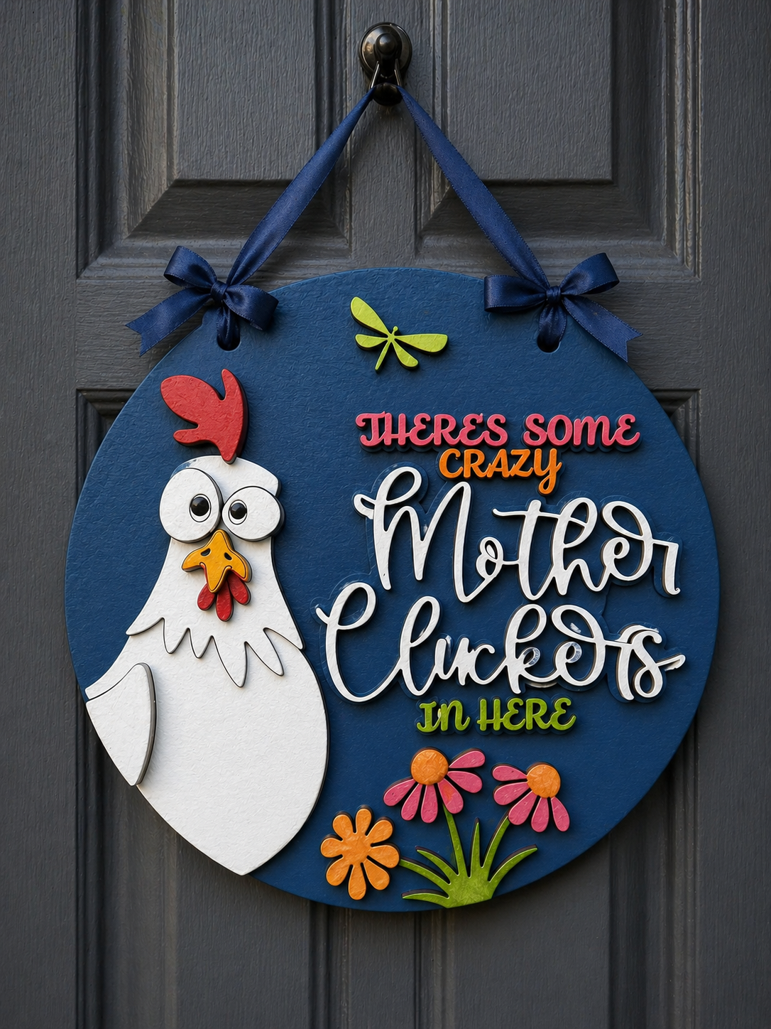 An unassembled Layered MDF Hanging Plaque featuring a circular base and separate pieces for a chicken and the text "There's some crazy mother cluckers in here."