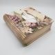 The Book Shaped Tissue Box Holder in 4mm MDF, highlighting its novelty curved living hinge spine while holding a standard tissue box.