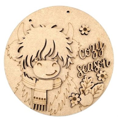 Cozy Season wood blank Door Plaque showing a 20cm round wooden sign with a layered Highland cow wearing a winter scarf next to cozy season script lettering.